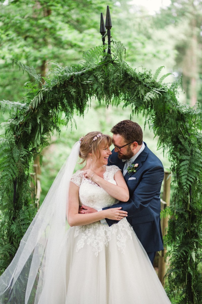 Under the arch in the woodlands by the oak tree